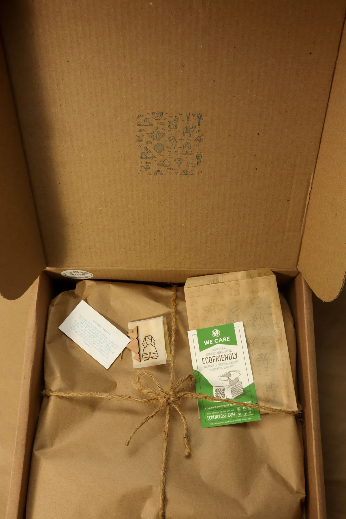 Open cardboard parcel with paper wrapping and natural packing materials