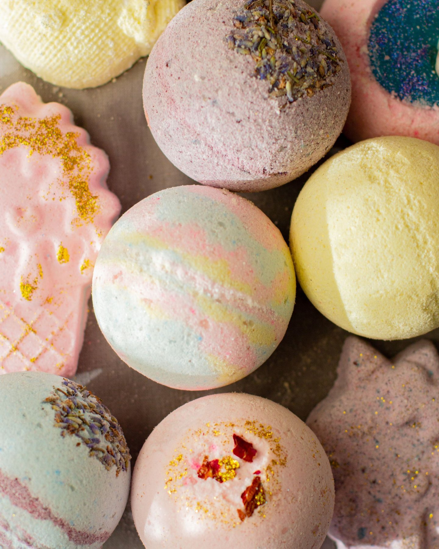 Round and shaped bath bombs with different surface textures arranged together