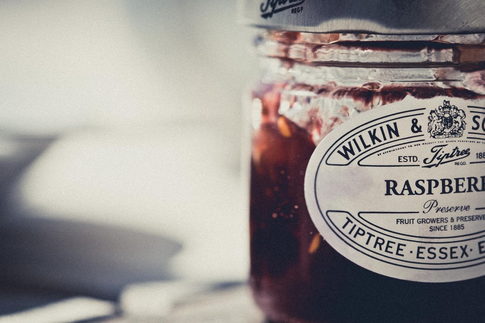A raspberry preserve jar with a printed retail product label