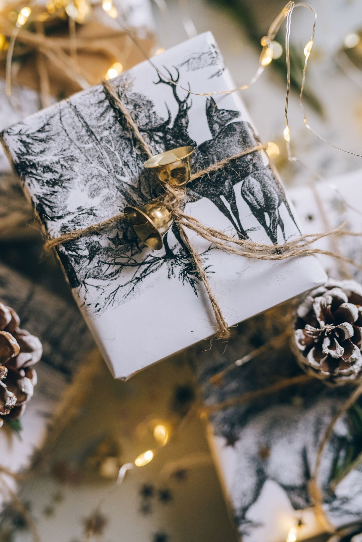 Deer-patterned Christmas wrapping paper secured with twine
