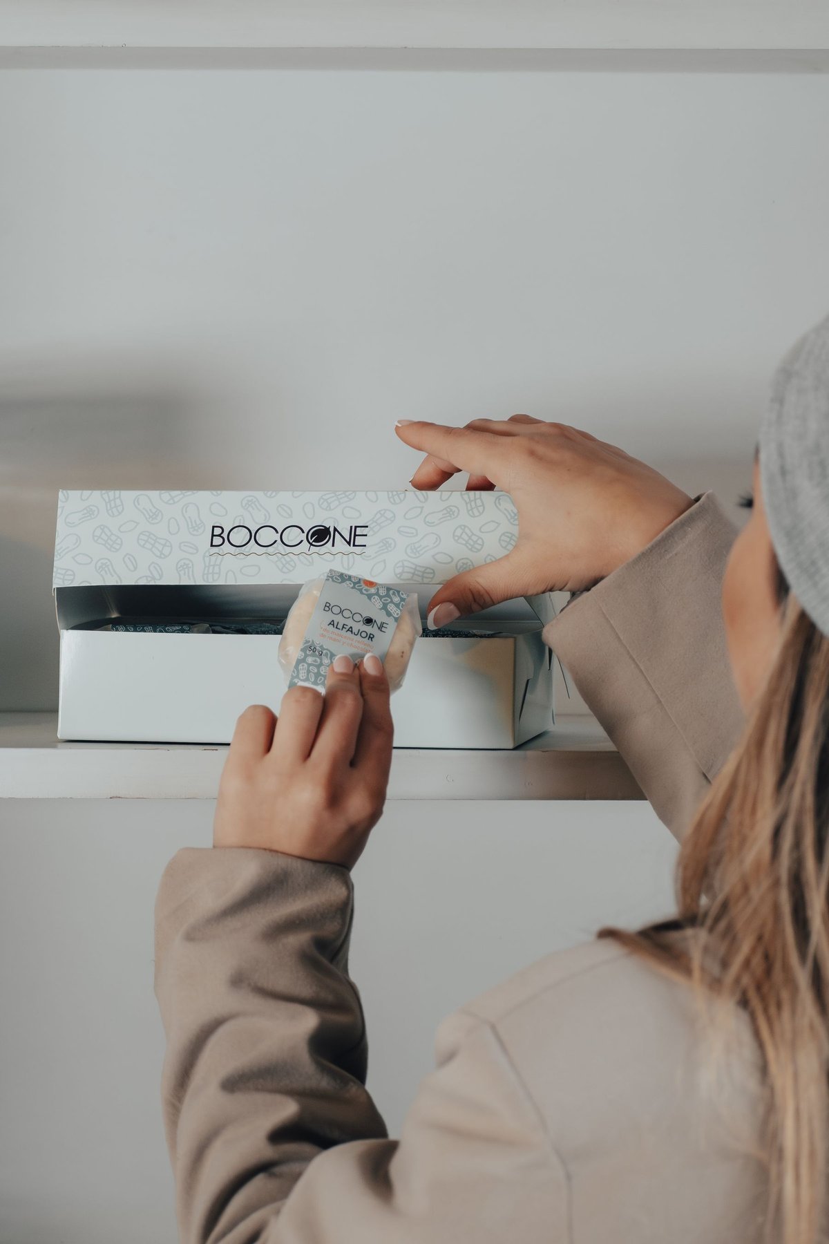 A recipient opening a branded presentation box in a retail setting