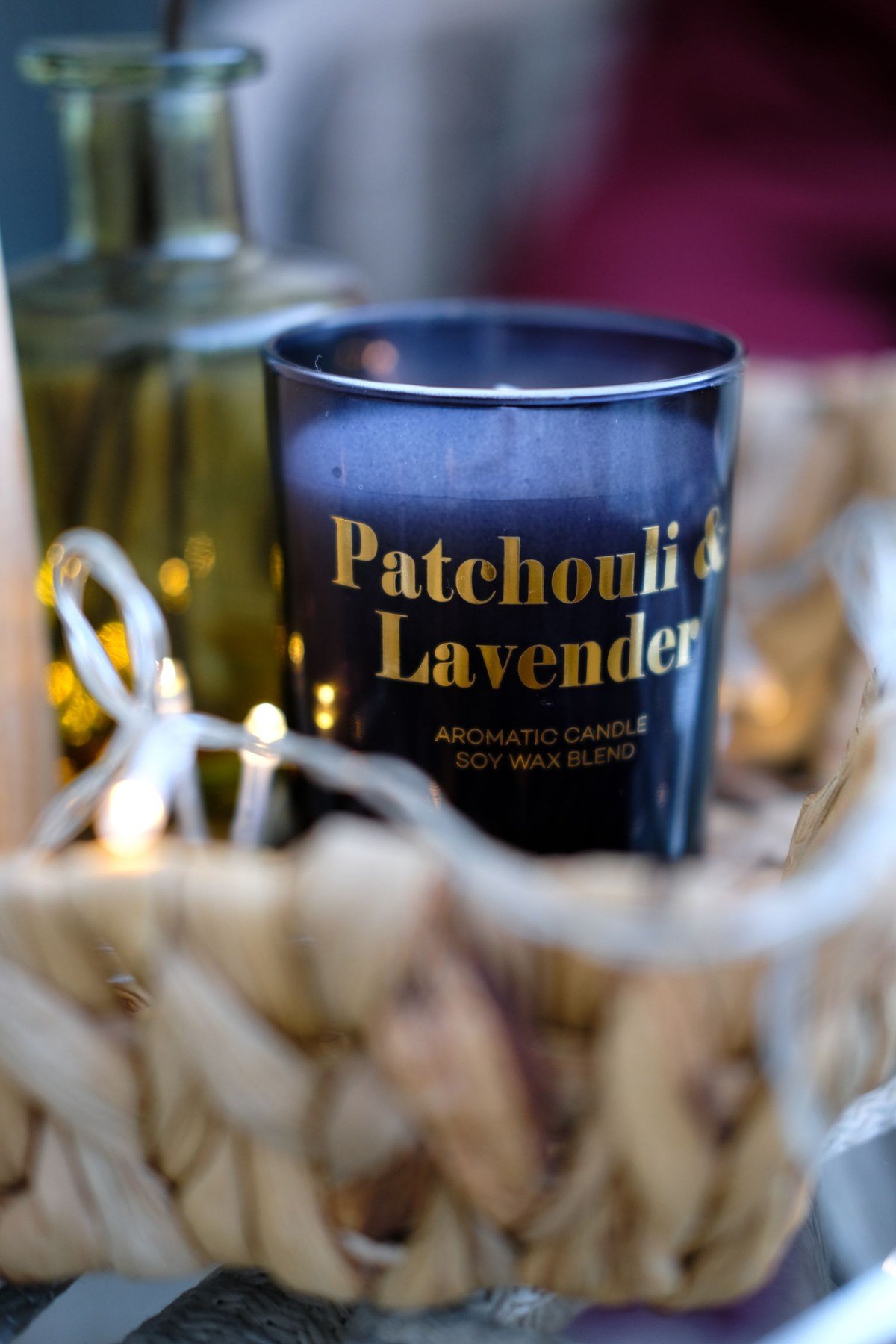 A blue candle container with the scent name Patchouli and Lavender