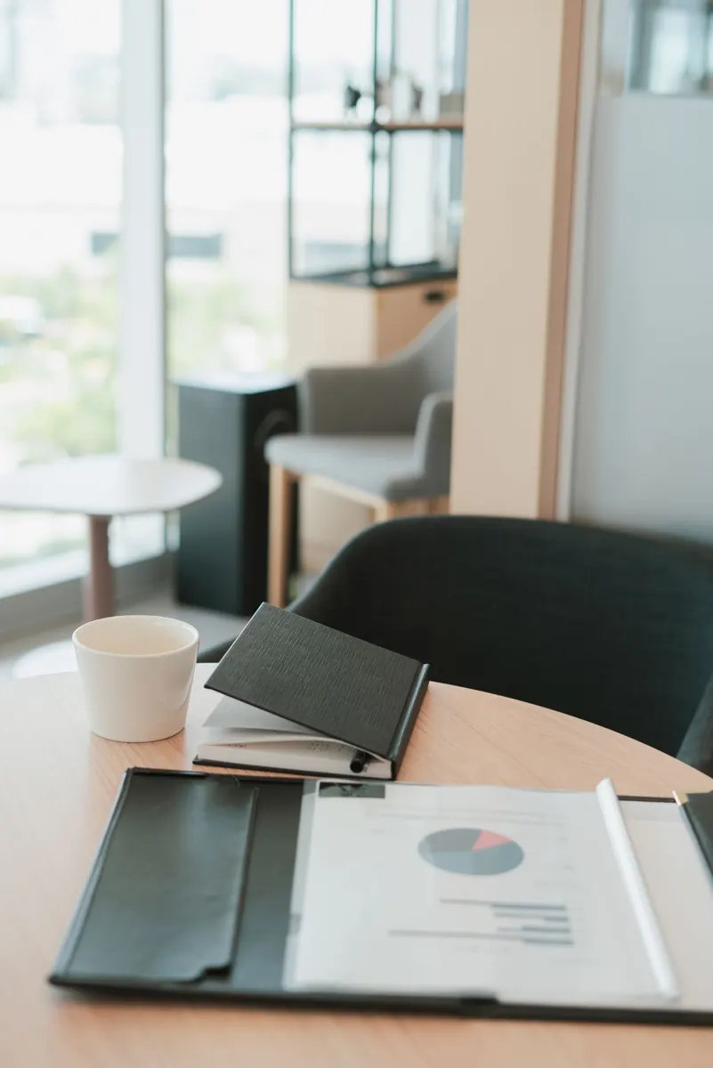 Notebook and project documents on a desk