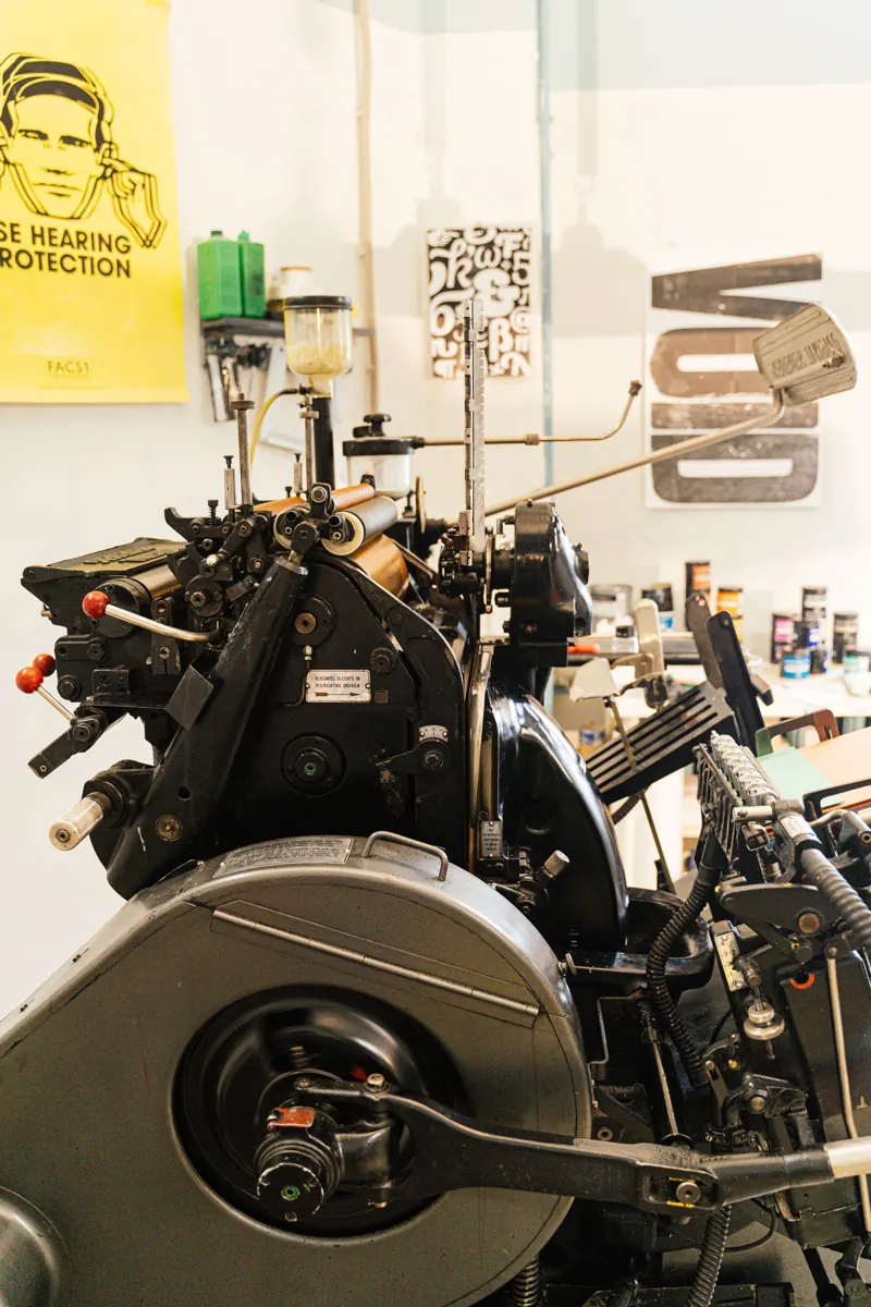 Printing press and paper in a graphic design studio