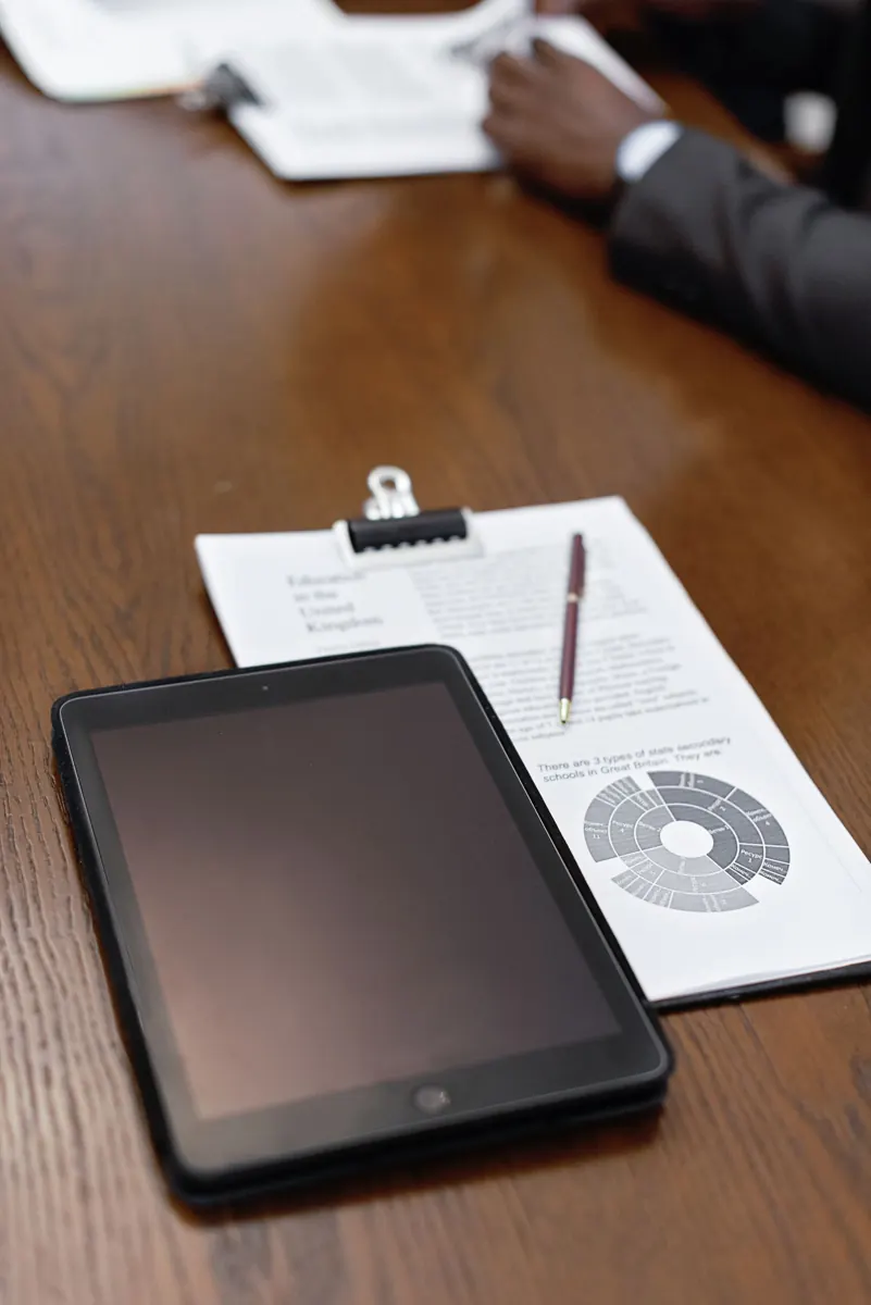 Tablet and printed data prepared for a reporting discussion