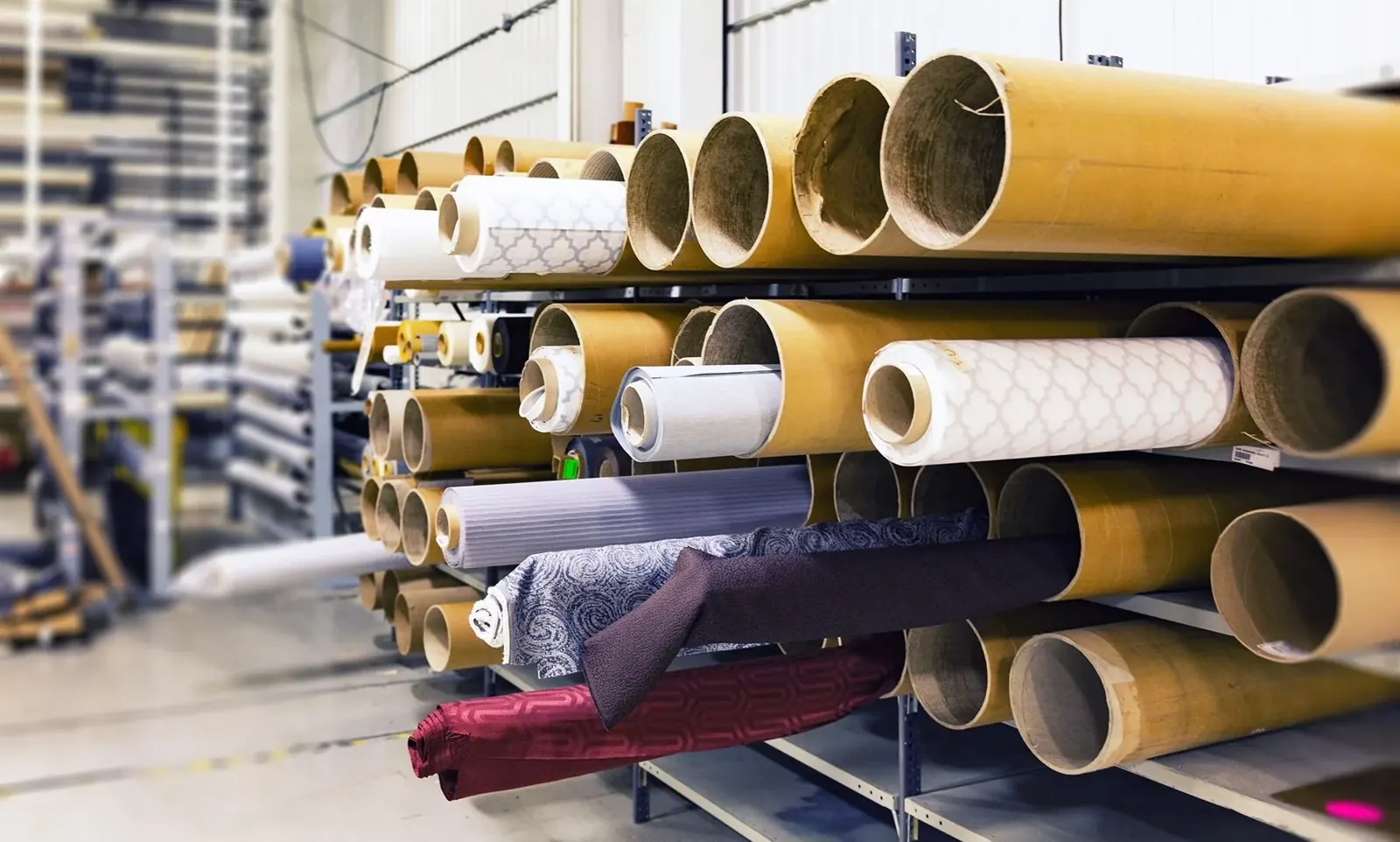 Rows of textile rolls stored for garment and bag production